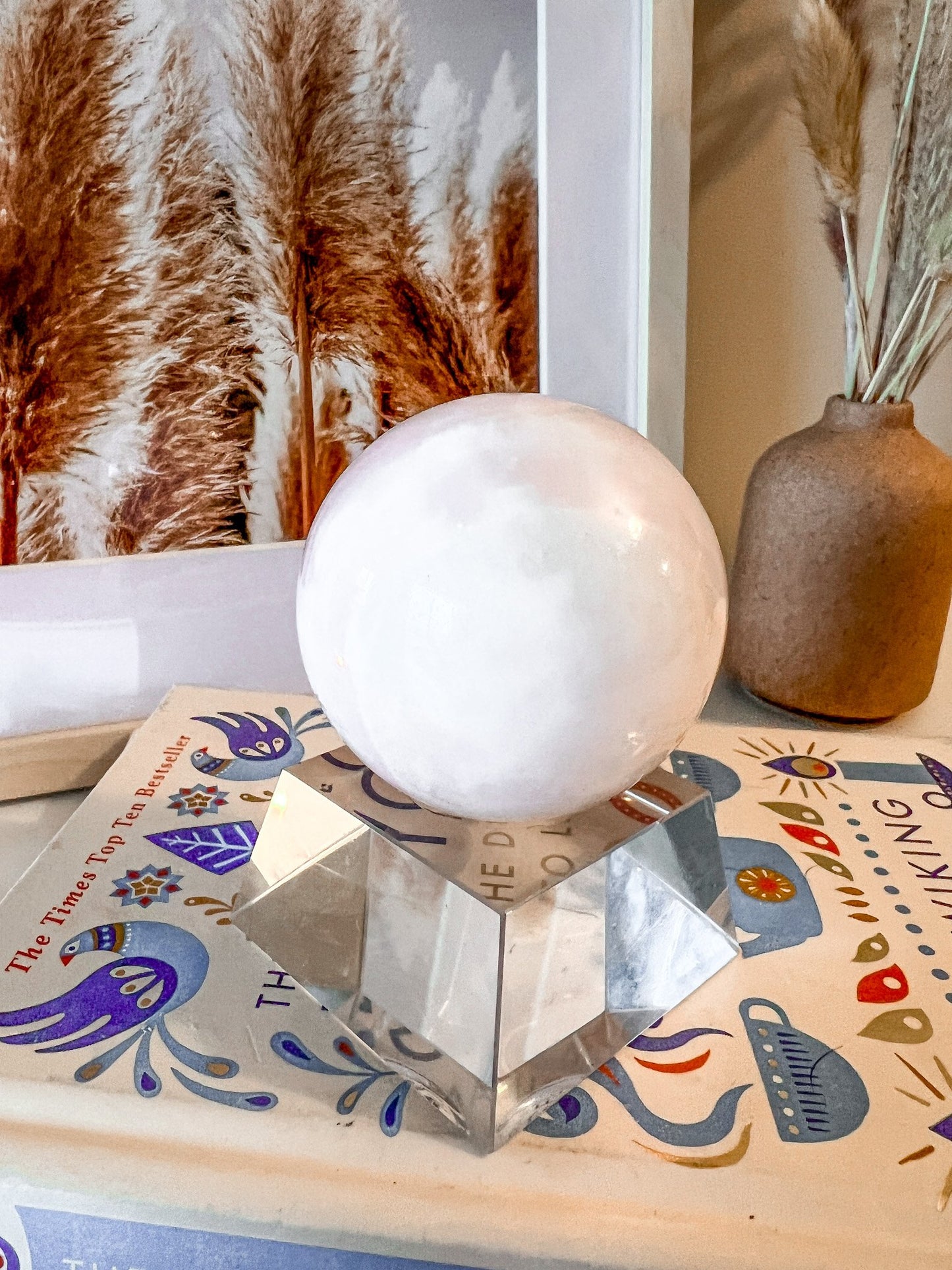 pink mangano calcite sphere on stand