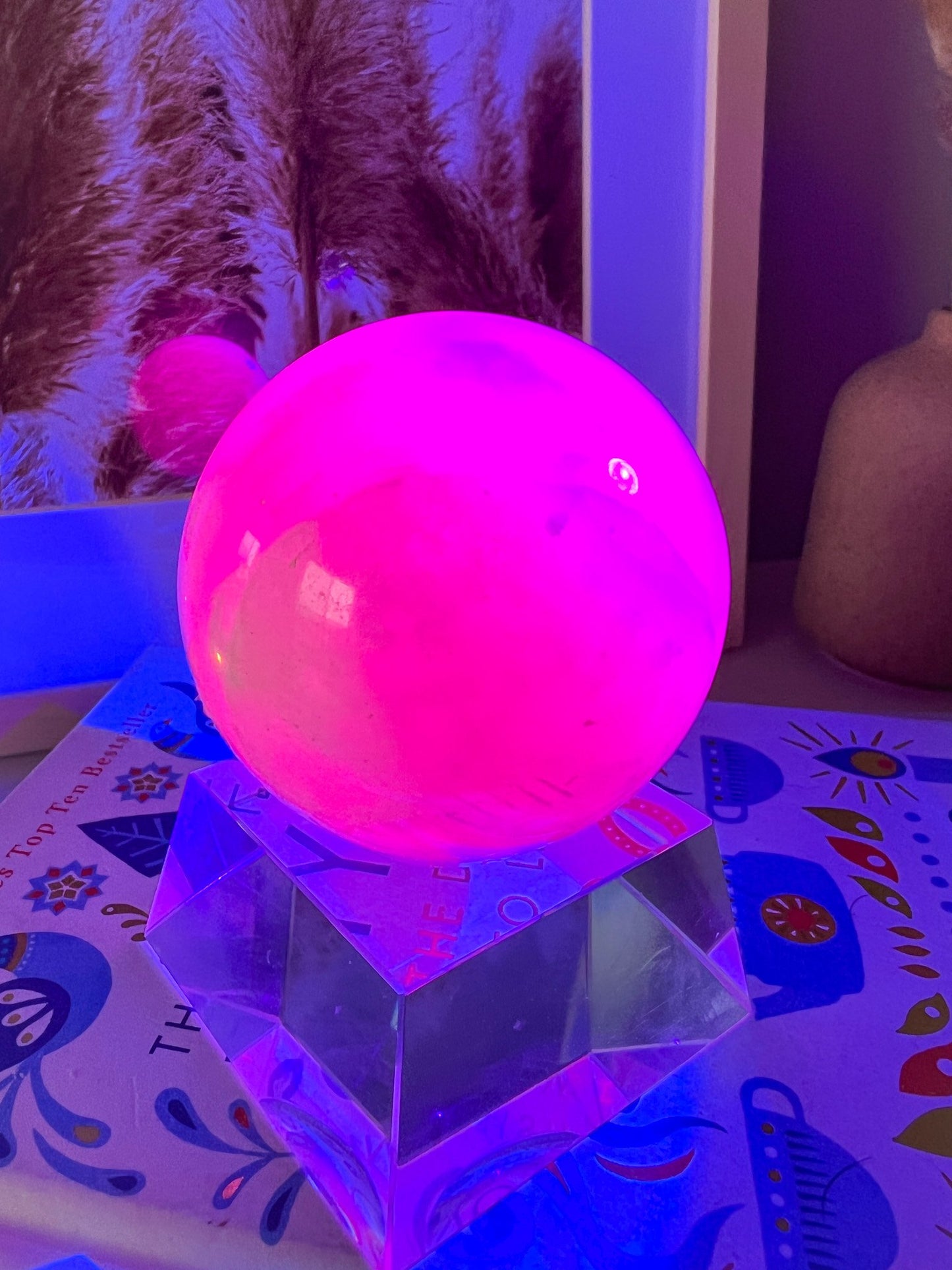 pink mangano calcite sphere on stand